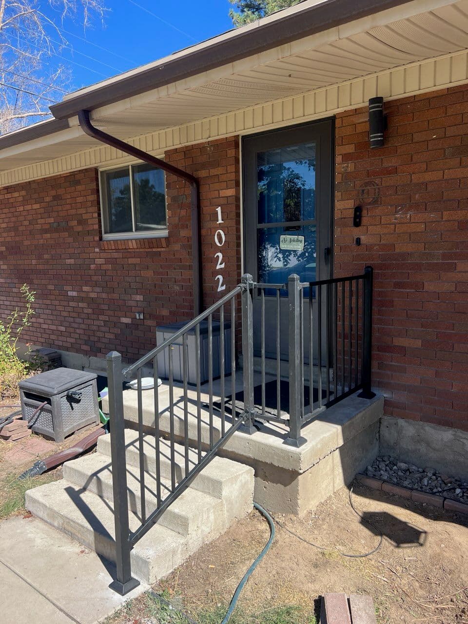 Gallery photos for Stylish Black Metal Railing Installation Adds Safety and Elegance to Brick House Entrance: Image #1
